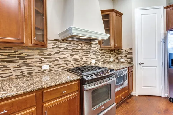 a kitchen with granite countertop a stove and a sink