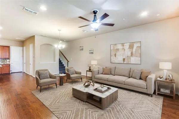 a living room with furniture and a wooden floor