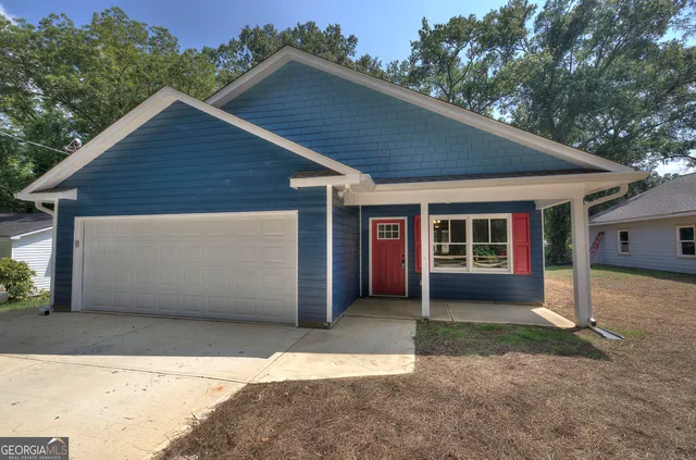 a front view of house with a yard and garage