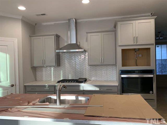 a kitchen with a stove and a cabinets