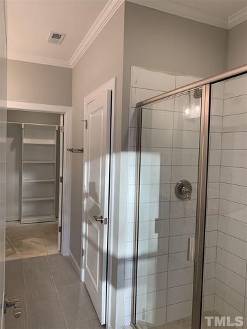 a bathroom with a glass shower door