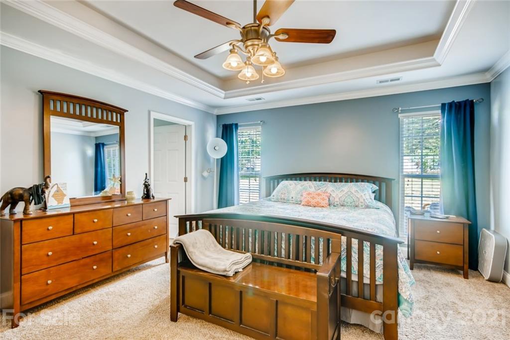 1682 Lane Road Mount Holly, NC 28120 - Photo 15 of 23 a bedroom with a bed and a chandelier