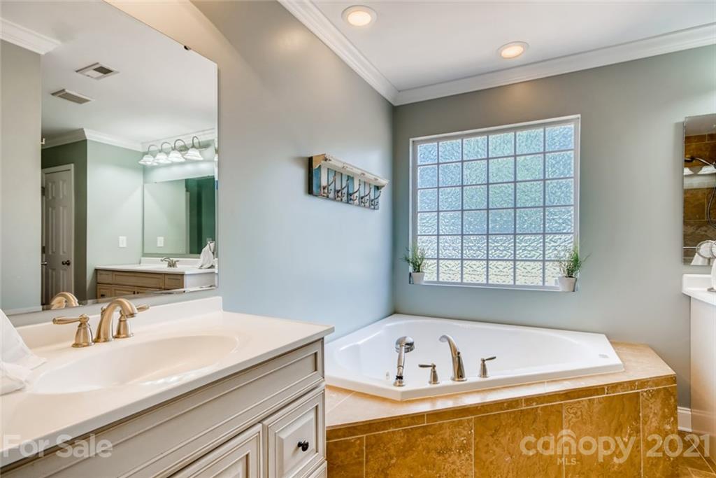 1682 Lane Road Mount Holly, NC 28120 - Photo 17 of 23 a bathroom with a tub a sink and mirror