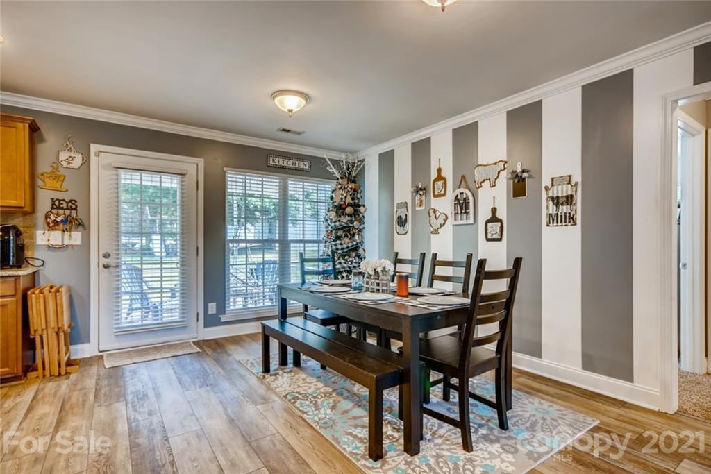1682 Lane Road Mount Holly, NC 28120 - Photo 20 of 23 a view of a dining room with furniture and wooden floor