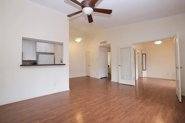 a view of a livingroom with a ceiling fan and wooden floor