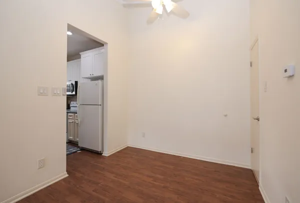 an empty room with wooden floor and closet