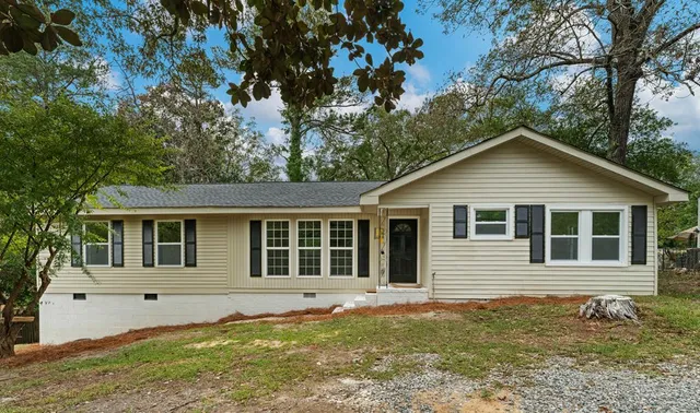 a house with trees in the background