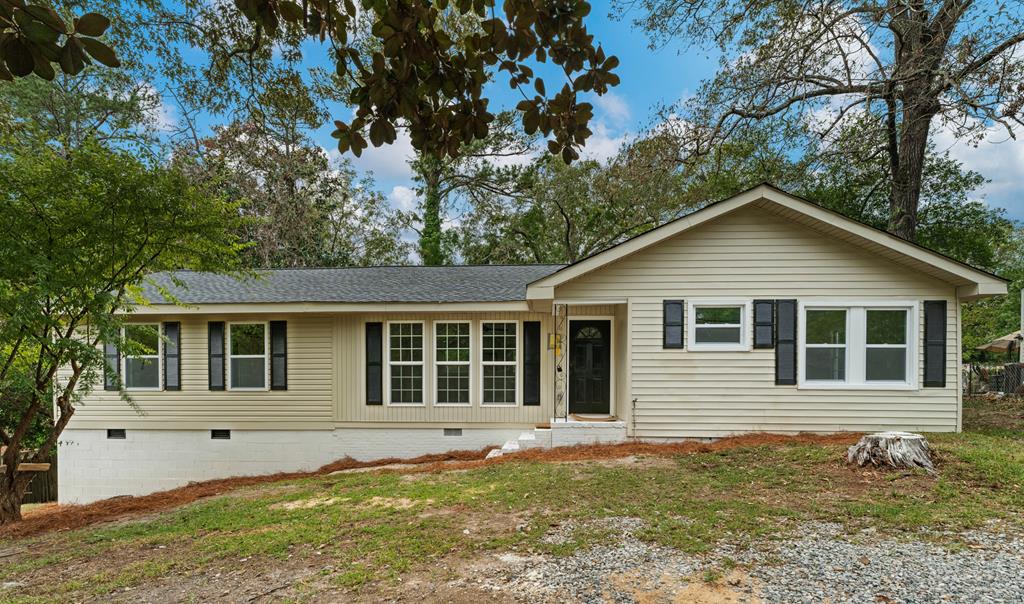 a house with trees in the background