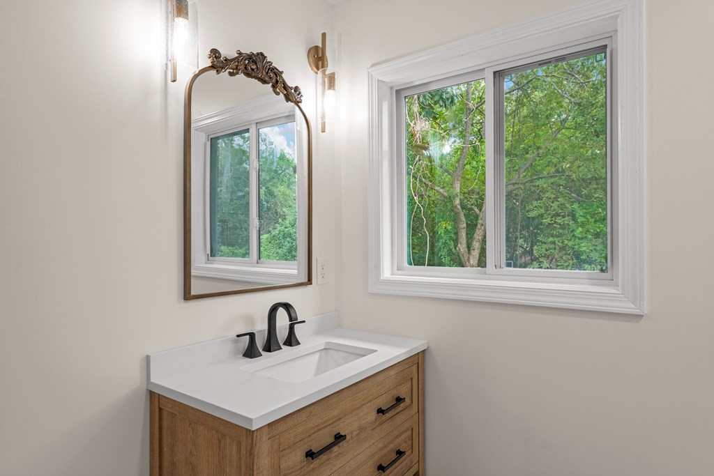5915 Frazier Drive Columbus, GA 31909 - Photo 16 of 28 a bathroom with a sink vanity and a mirror