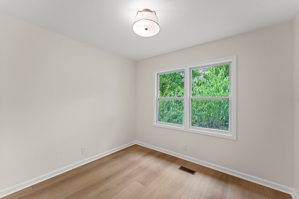 5915 Frazier Drive Columbus, GA 31909 - Photo 18 of 28 an empty room with wooden floor and windows