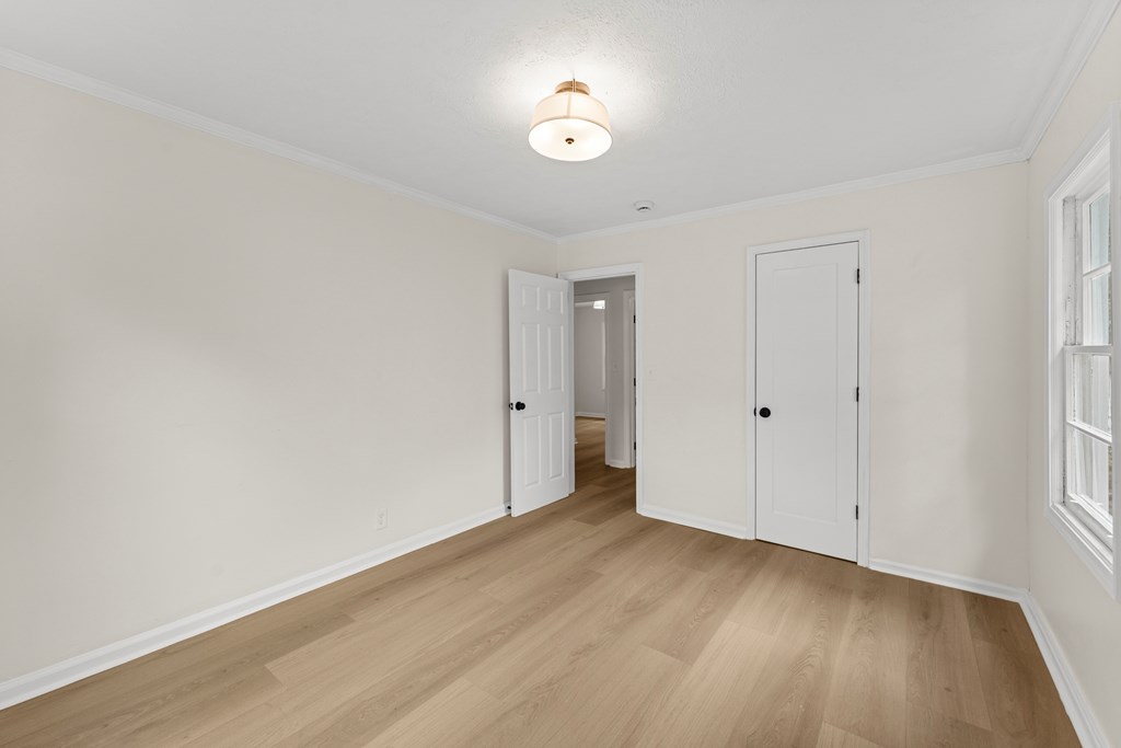 5915 Frazier Drive Columbus, GA 31909 - Photo 25 of 28 a view of an empty room with wooden floor and a window
