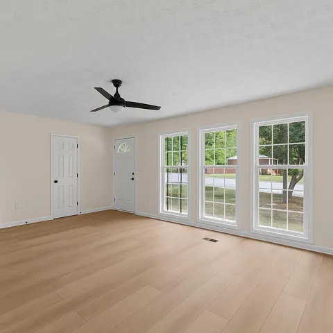 a kitchen with a refrigerator and white cabinets