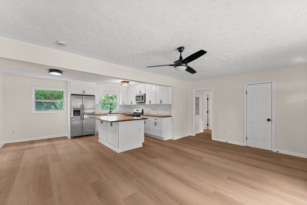 5915 Frazier Drive Columbus, GA 31909 - Photo 6 of 28 a kitchen with a refrigerator and white cabinets