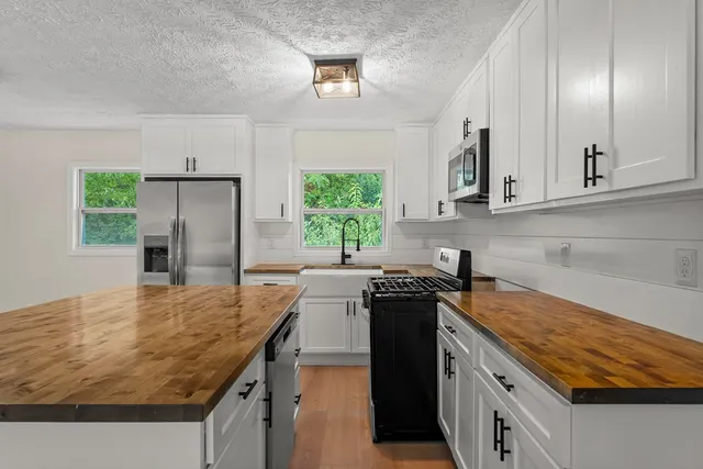 a kitchen with a sink stove and microwave