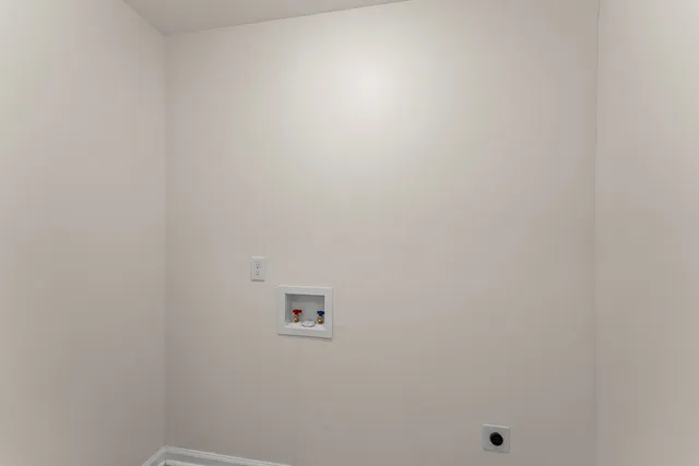 an empty room with windows and entrance