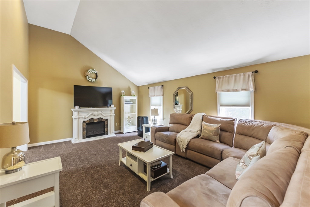 67 Roxy Cahoon Road Plymouth, MA 02360 - Photo 11 of 37 a living room with furniture flat screen tv and a fireplace