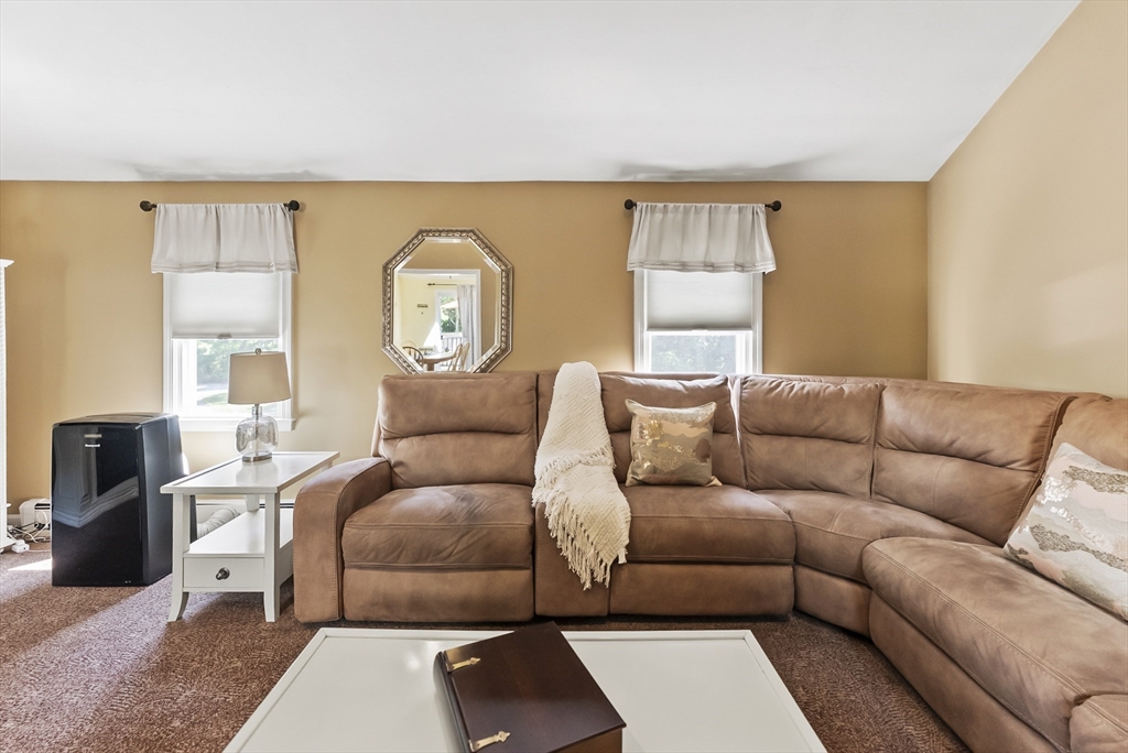 67 Roxy Cahoon Road Plymouth, MA 02360 - Photo 13 of 37 a living room with a couch and a lamp with wooden floor