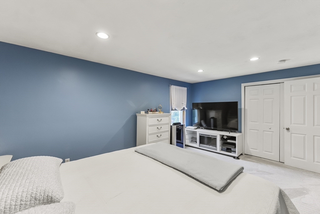 67 Roxy Cahoon Road Plymouth, MA 02360 - Photo 16 of 37 a bedroom with a bed and a flat screen tv