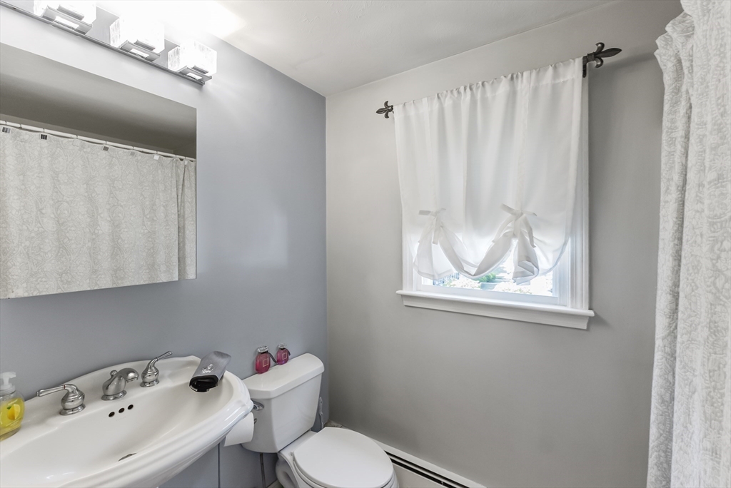 67 Roxy Cahoon Road Plymouth, MA 02360 - Photo 17 of 37 a bathroom with a sink a window and a toilet