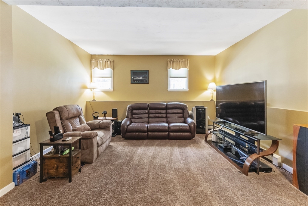 67 Roxy Cahoon Road Plymouth, MA 02360 - Photo 20 of 37 a living room with furniture and a flat screen tv