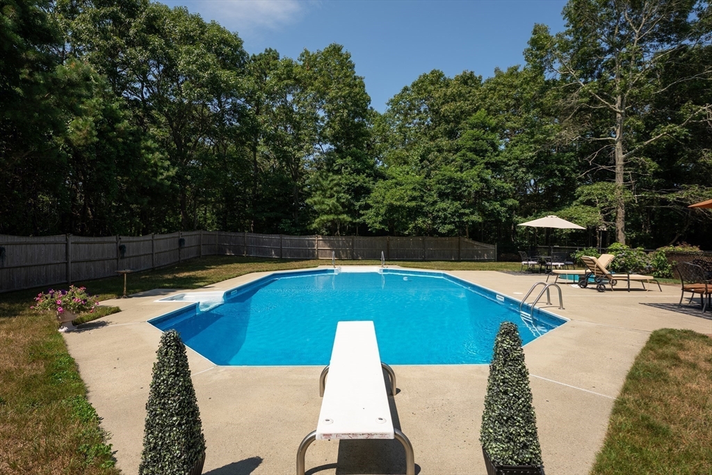 67 Roxy Cahoon Road Plymouth, MA 02360 - Photo 2 of 37 a view of swimming pool with seating area and trees in the background