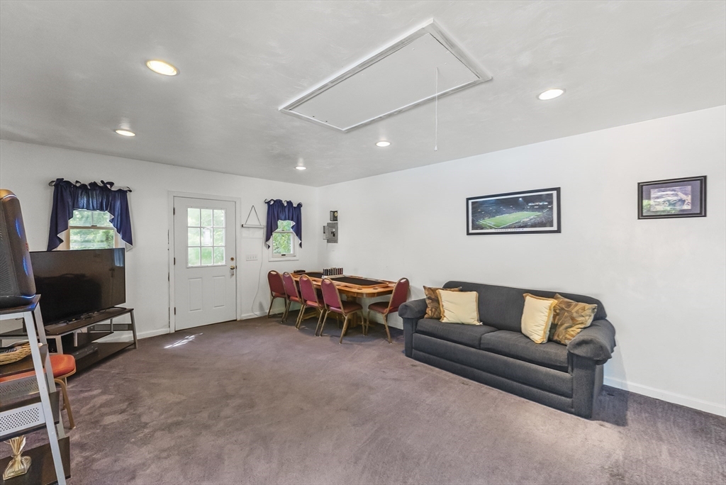67 Roxy Cahoon Road Plymouth, MA 02360 - Photo 34 of 37 a living room with furniture and a flat screen tv
