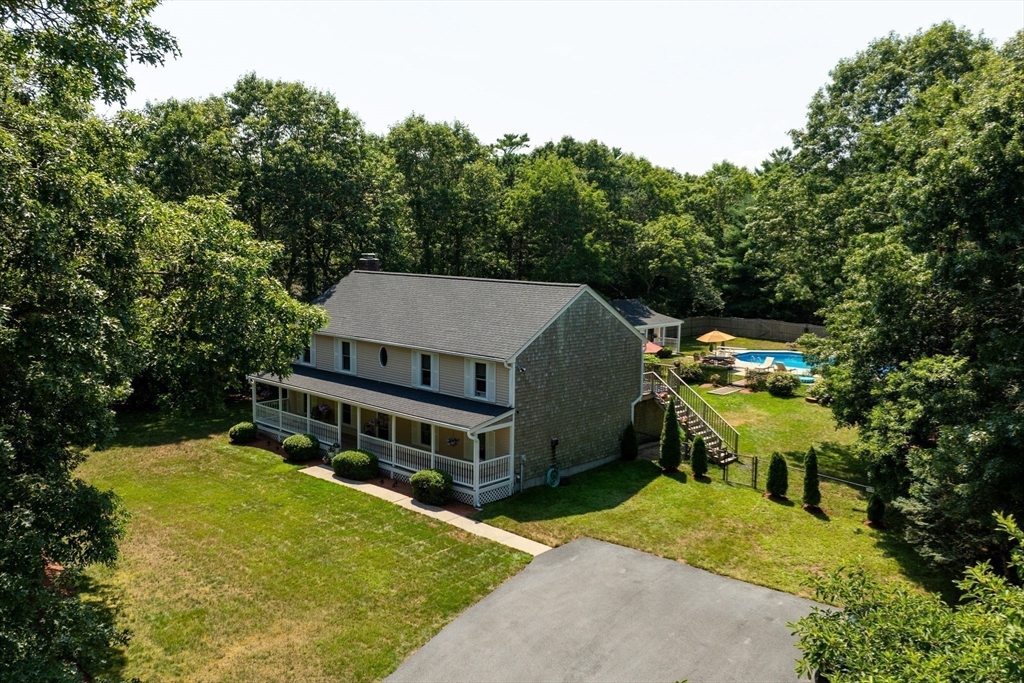 67 Roxy Cahoon Road Plymouth, MA 02360 - Photo 4 of 37 an aerial view of a house with a yard table and chairs