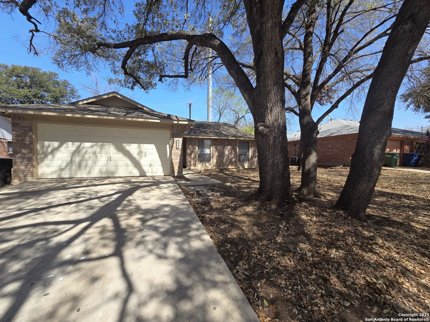 6911 Brookport Leon Valley, TX 78238 - Photo 1 of 1 a view of a yard with plants and a large tree