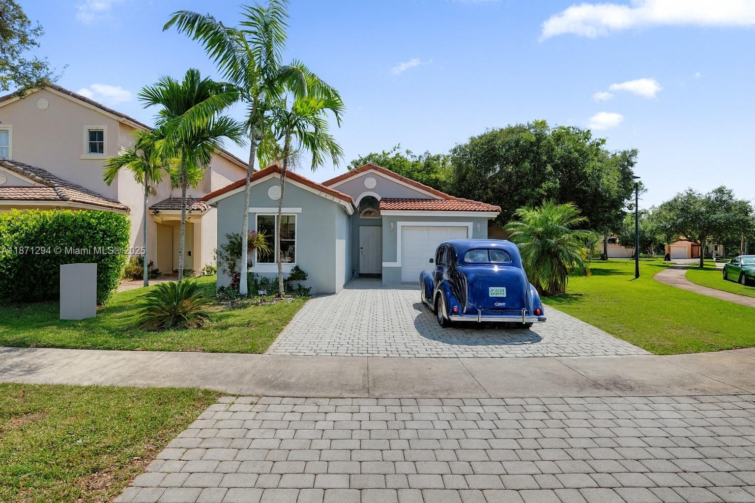 a car parked in front of a house with a yard