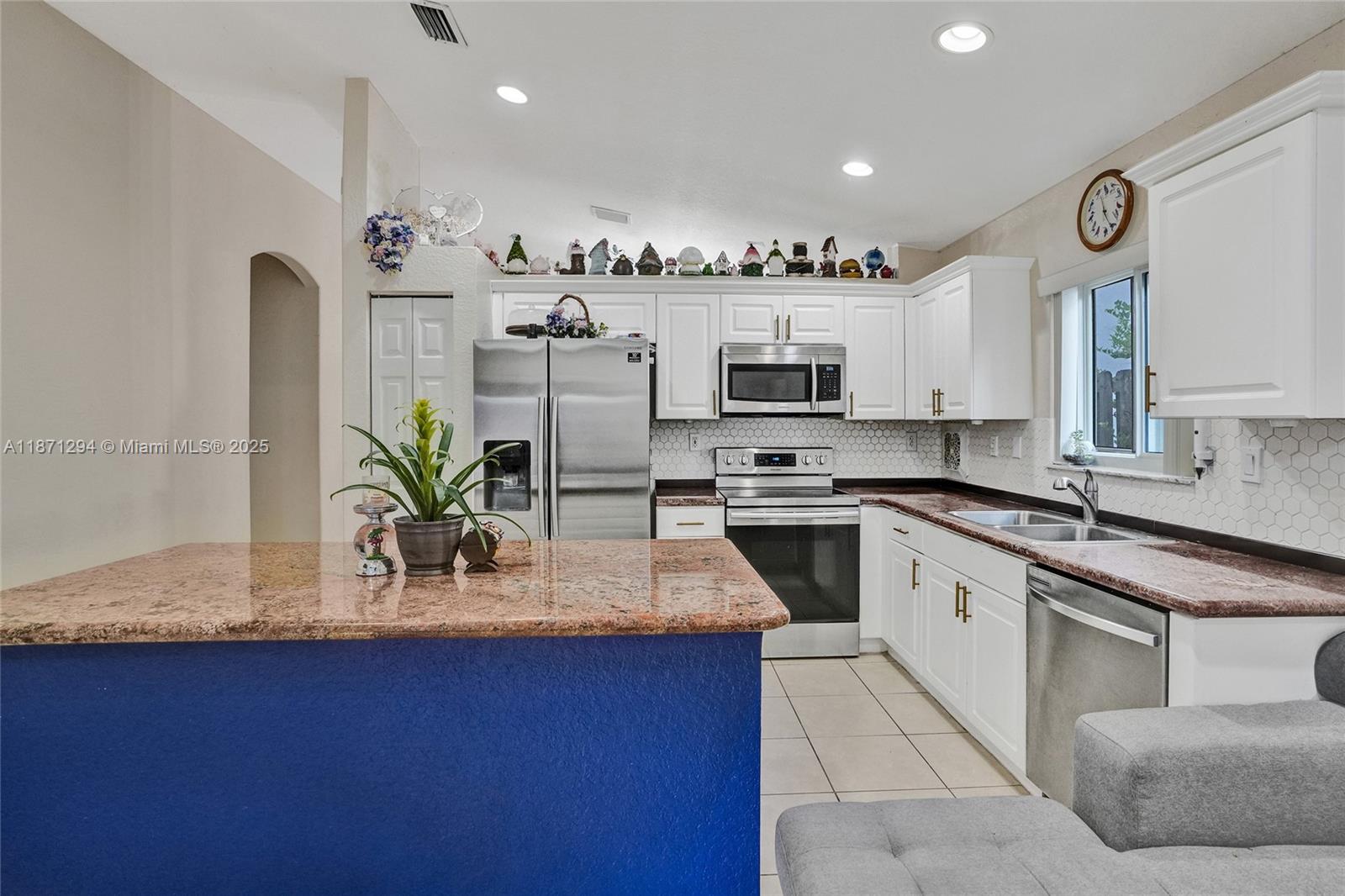 1635 Southeast 20th Place Homestead, FL 33035 - Photo 13 of 19 a kitchen with stainless steel appliances granite countertop a sink counter space and cabinets