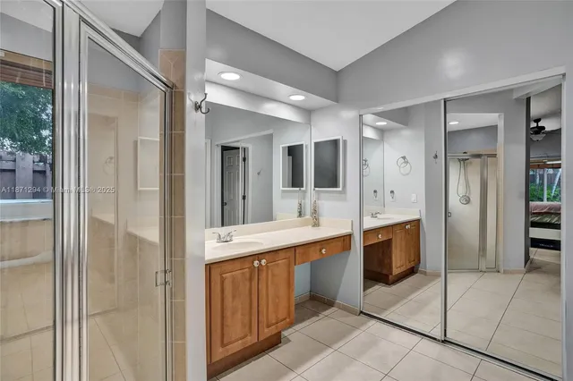 a large bathroom with a glass shower door a sink and a mirror