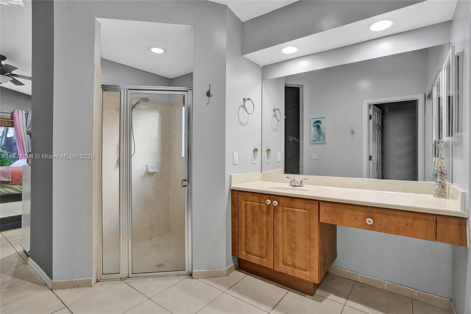 1635 Southeast 20th Place Homestead, FL 33035 - Photo 18 of 19 a spacious bathroom with a granite countertop sink and a mirror