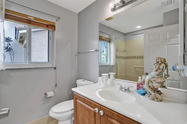 a bathroom with a toilet sink and mirror