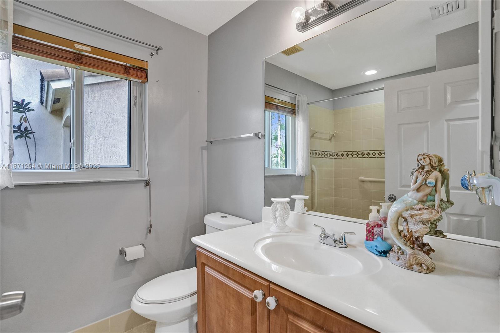 1635 Southeast 20th Place Homestead, FL 33035 - Photo 6 of 19 a bathroom with a toilet sink and mirror