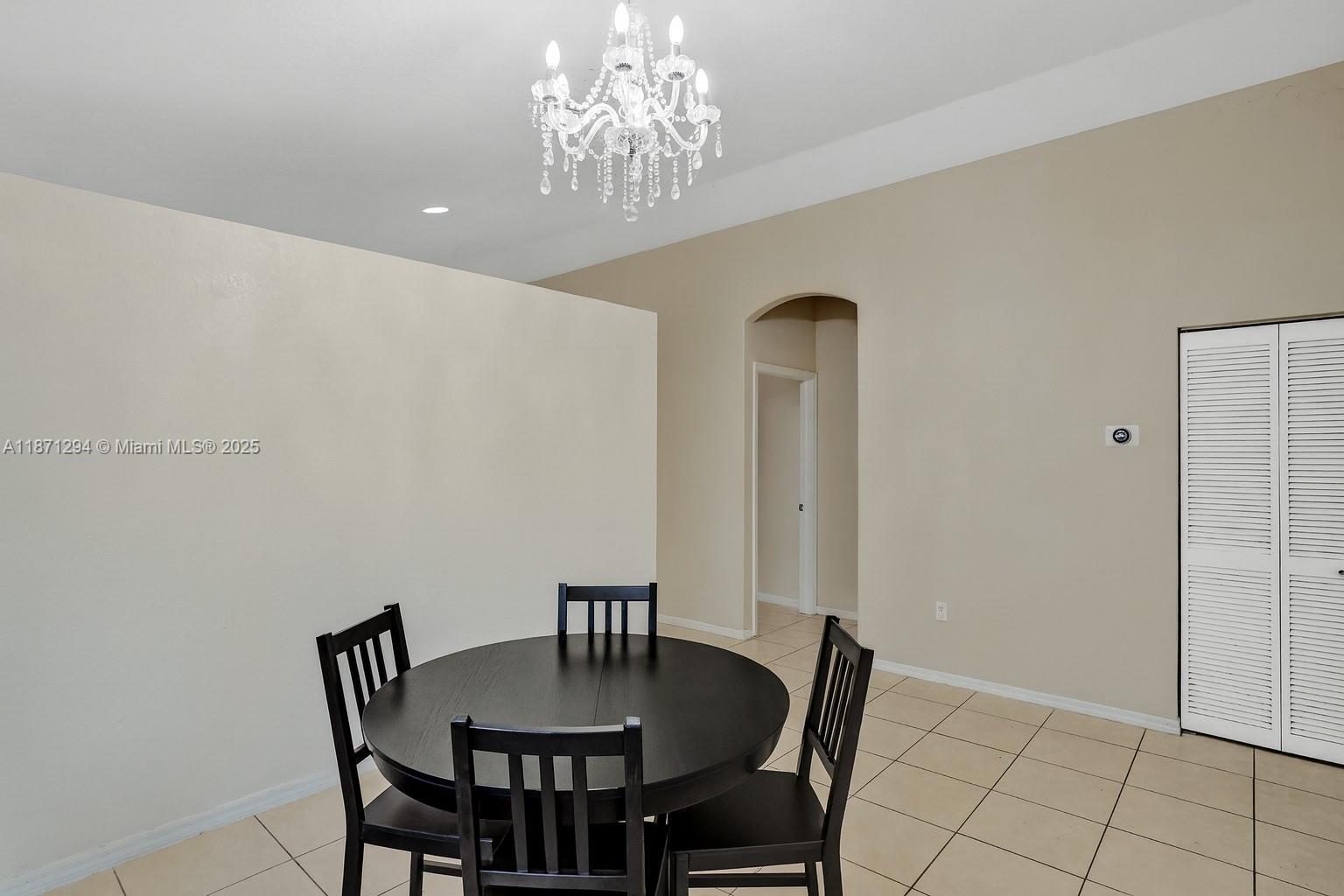 1635 Southeast 20th Place Homestead, FL 33035 - Photo 10 of 19 a view of a dining room with furniture and chandelier