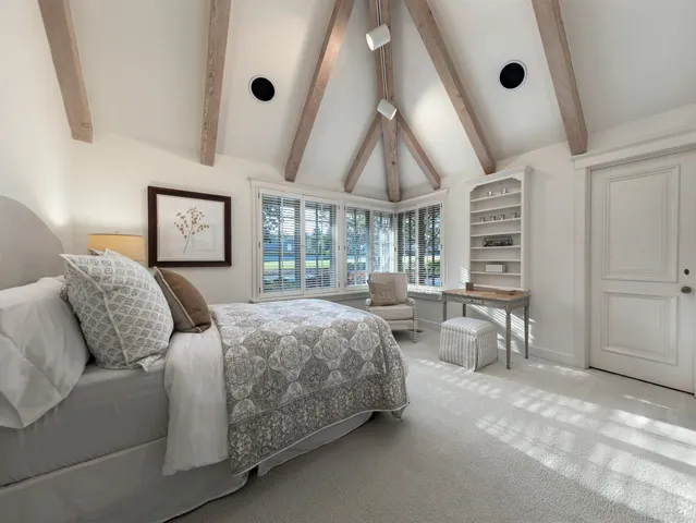 a bedroom with a large bed and a large window