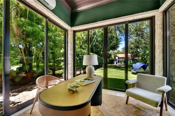 a room with pool table and two chairs