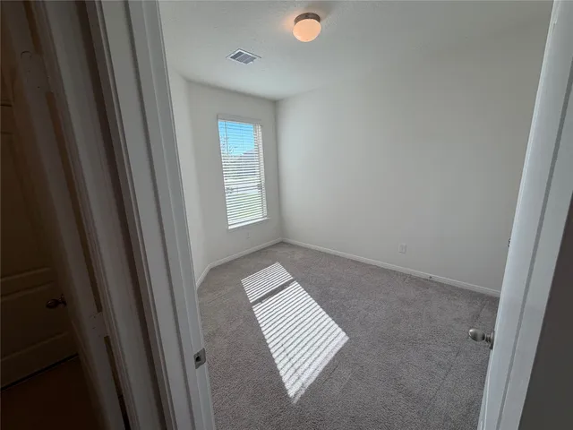 a view of wooden floor and windows in a room