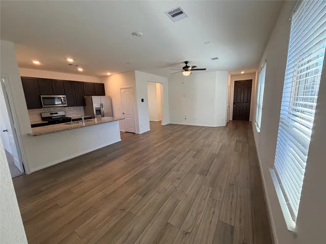 a view of a kitchen with a sink and microwave