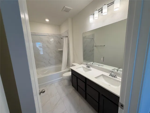 a bathroom with a sink a mirror and a bathtub