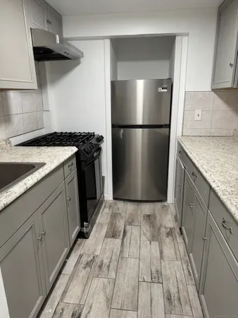 a kitchen with a sink a refrigerator and a stove