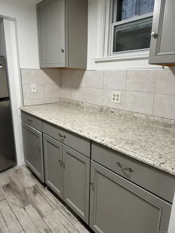 a kitchen with granite countertop cabinets and white stainless steel appliances