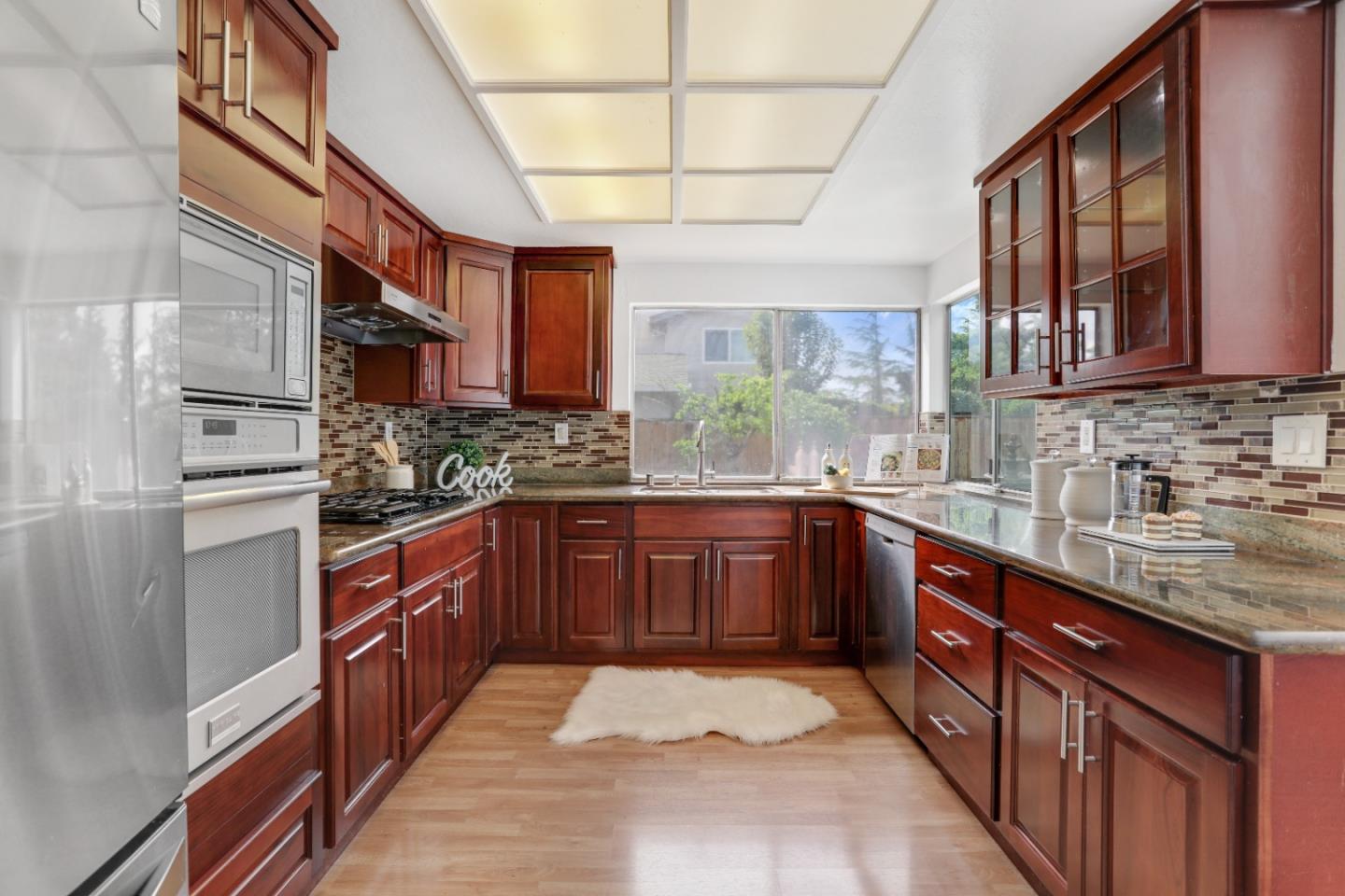 537 Santander Drive San Ramon, CA 94583 - Photo 11 of 28 a kitchen with stainless steel appliances granite countertop a sink stove and cabinets