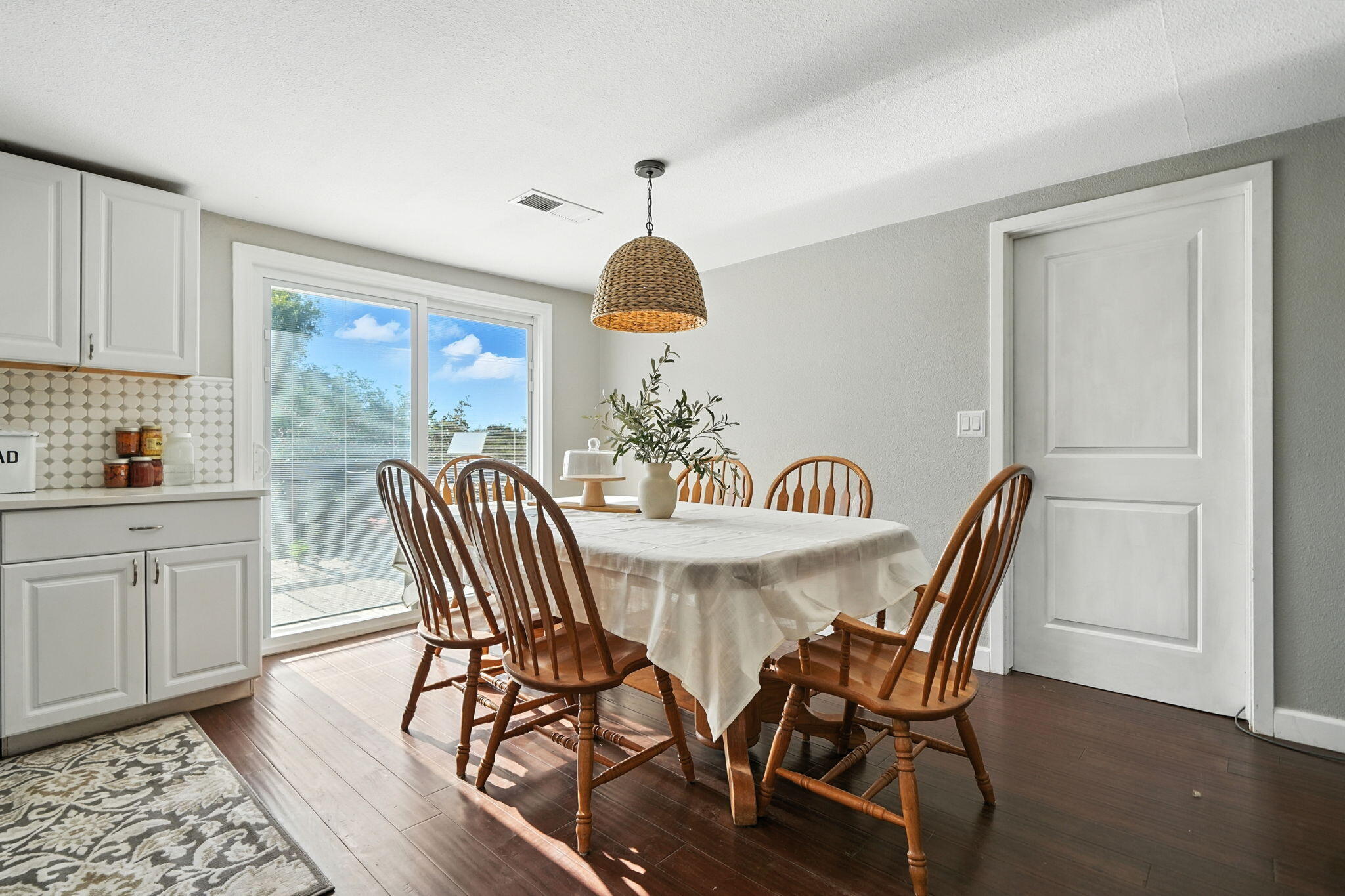 22945 Adobe Road Cottonwood, CA 96022 - Photo 11 of 40 a dining room with furniture a chandelier and wooden floor