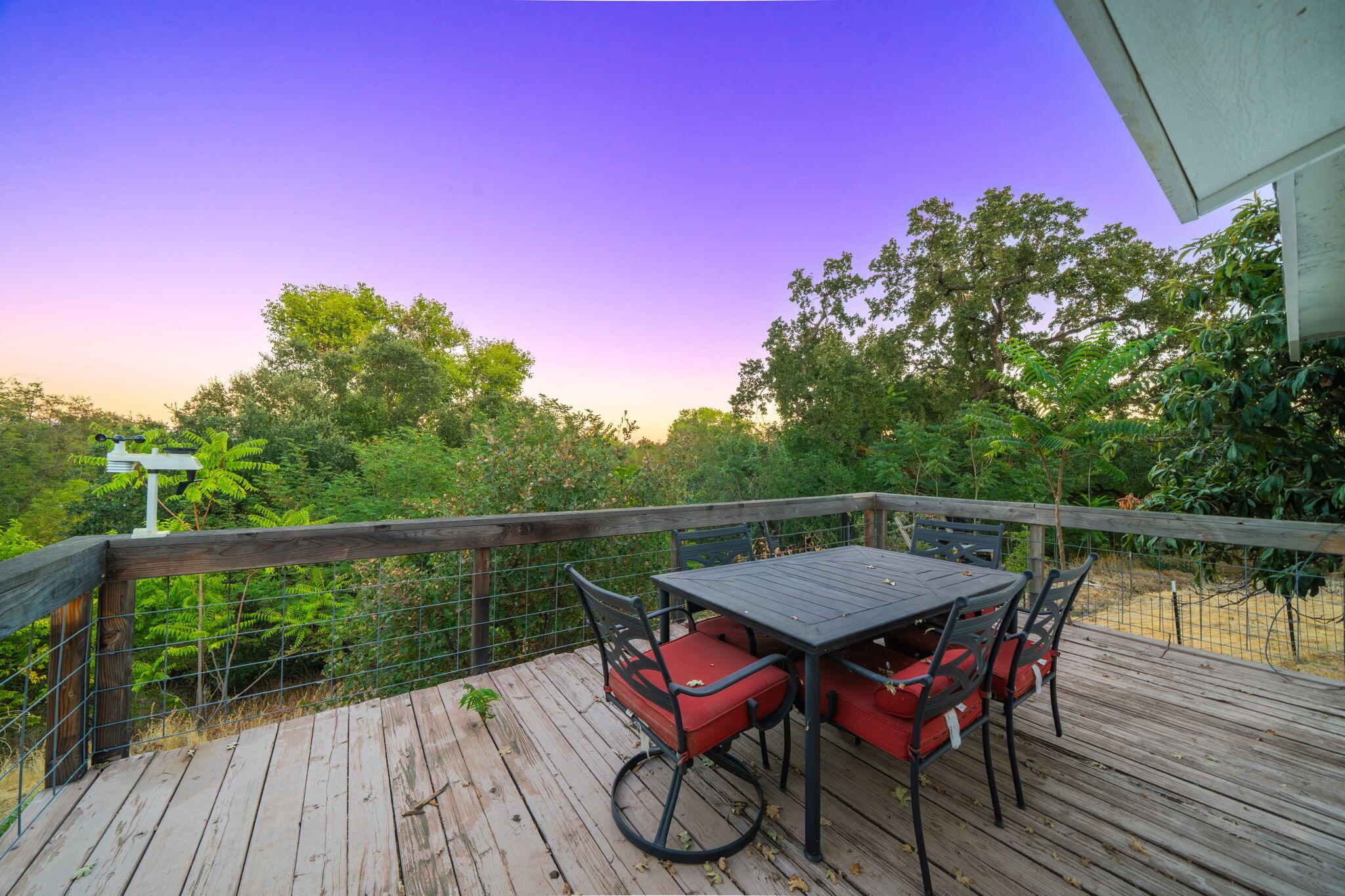 22945 Adobe Road Cottonwood, CA 96022 - Photo 16 of 40 a balcony with wooden floor table and chairs