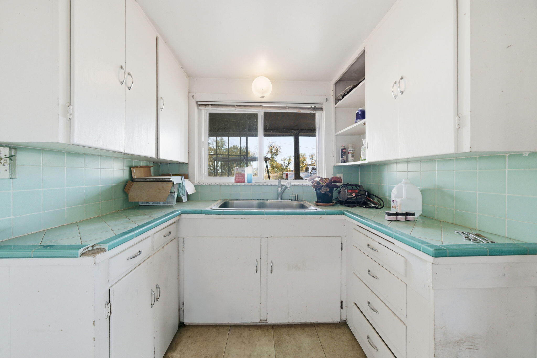 22945 Adobe Road Cottonwood, CA 96022 - Photo 32 of 40 a kitchen with white cabinets and white appliances