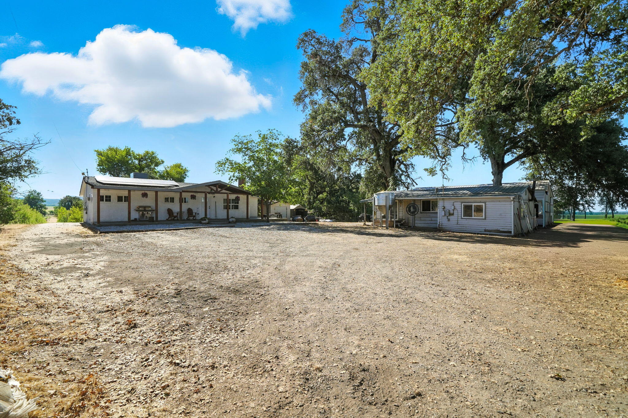 22945 Adobe Road Cottonwood, CA 96022 - Photo 4 of 40 a view of a house with a yard and a large tree