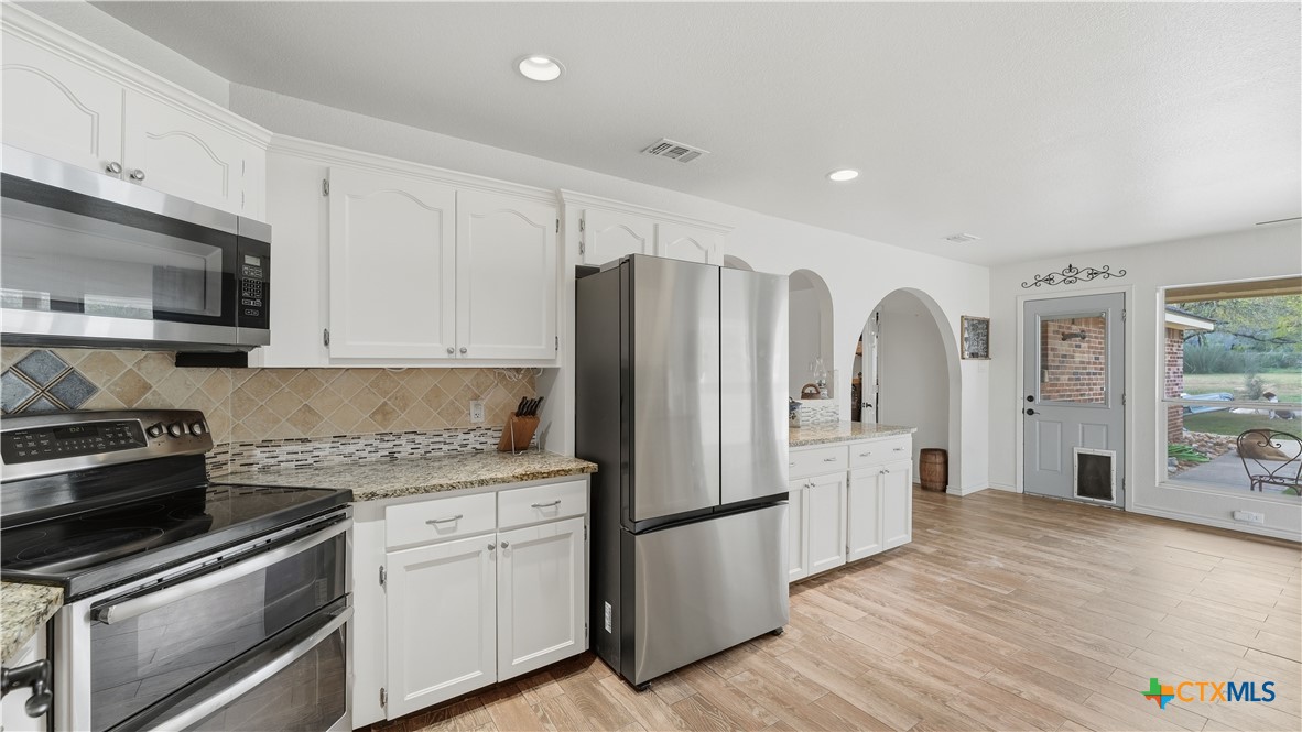 195 Cheyenne Lane Kingsbury, TX 78638 - Photo 7 of 43 a kitchen with stainless steel appliances a refrigerator sink and microwave