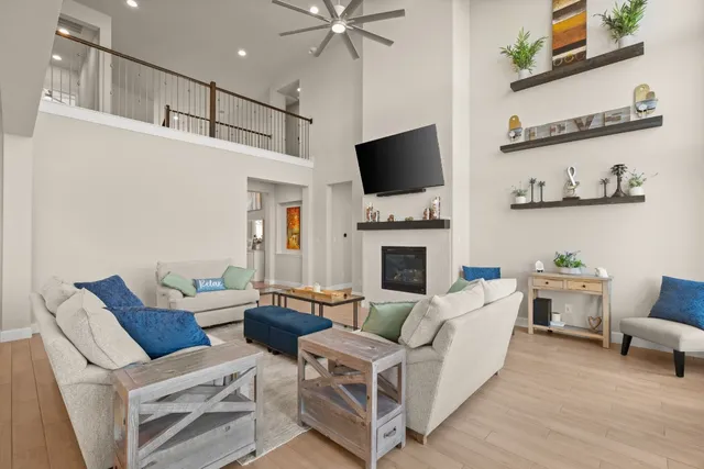 a living room with furniture a flat screen tv and a fireplace