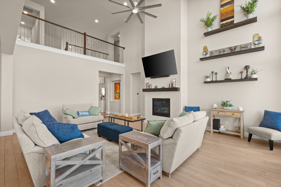 108 Rosetta Loop Liberty Hill, TX 78642 - Photo 11 of 40 a living room with furniture a flat screen tv and a fireplace